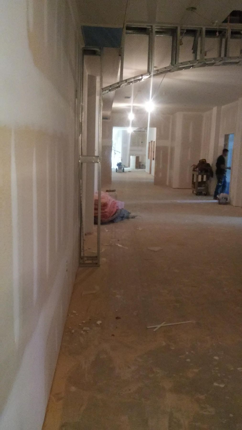 Commercial corridor with metal stud framing and new drywall
