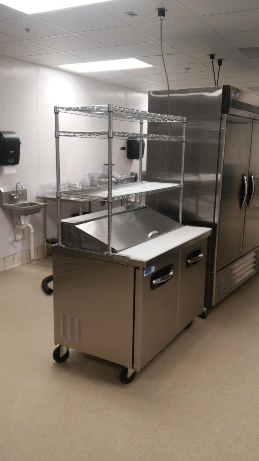 Finished commercial kitchen with prep station and refrigeration